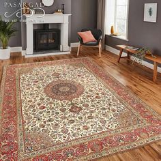 a living room filled with furniture and a rug on top of a hard wood floor