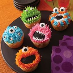 cupcakes decorated to look like monsters on a plate