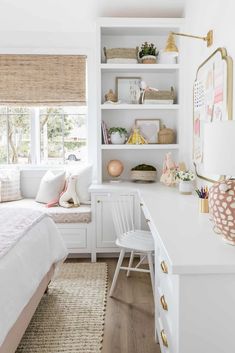 a bedroom with white furniture and lots of bookshelves on the shelves in it