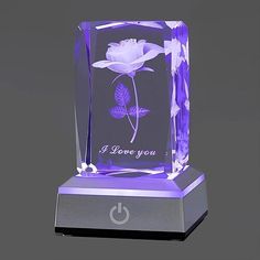 a purple glass block with a flower on it and the words i love you written in white