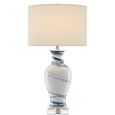 a blue and white lamp with a beige shade