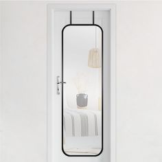 a white door with a mirror on the front and side panels that are black in color