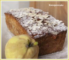 a loaf of bread with powdered sugar on top and an apple next to it