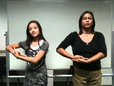 two women standing next to each other in an office