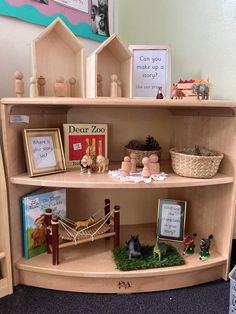 a book shelf filled with lots of books next to pictures and toy animals on top of it