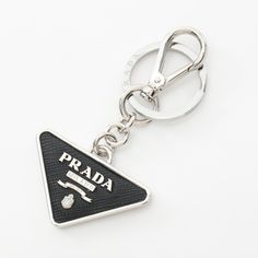 Used Prada Triangle Keychain, Saffiano Leather, Metal, Men's, Women's, Black, Silver, 2pp080053f0002 (Sku: Gzl1524y) === General === Brand : Prada === Design === Type : Keyring Gender : Men,Women Color : Black, Silver Material : Metal, Saffiano Metal === Size === Size (Hxwxd) : 9.5cm X 5cm / 3.74'' X 1.96'' === Included Items === Accessories : Box Accessories Notice : Before Purchasing, Please Refer To The Images Of The Accessories Included With The Item. === Condition === Condition : Opened (Ne Luxury Keychain, Prada Triangle, Black Ish, Keychain Craft, Prada Accessories, Prada Saffiano, Box Accessories, Accessories Box, Triangle Logo