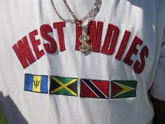 a person wearing a white shirt with the words west indiess on it and flags