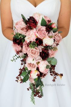 a bridal holding a bouquet of pink and red flowers