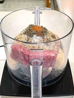 a food processor with meat and spices in it