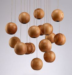 a group of wooden balls hanging from strings