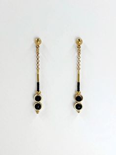 These earrings are dainty and minimalistic but detailed! Thick, straight cut, golden brass rings encircle each semi precious stone of matte black onyx, complimentary tiny, matte black glass seed beads sit above.  The shiny warm, golden brass contrasts beautifully with the deep black stone.  The simplicity and geometric shapes create a contemporary design.  A solid brass ball stud with stainless steel earring post sits at the top.  Approximate measurements- 5.5 cms long 0.75 cm wide All Set Theor Minimalist Matte Gold Metal Jewelry, Minimalist Metal Linear Earrings With Adjustable Chain, Minimalist Long Drop Brass Jewelry, Tarnish Resistant Black Dangle Jewelry, Black Tarnish Resistant Dangle Jewelry, Minimalist Black Pierced Jewelry, Minimalist Nickel-free Yellow Gold Linear Earrings, Minimalist Gold Plated Linear Earrings With Adjustable Chain, Minimalist Yellow Gold Linear Earrings Nickel Free