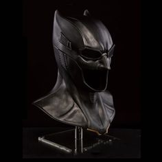 the dark knight mask is shown on a stand