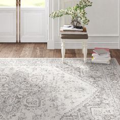 a white rug with an ornate design on the floor in front of a door and window