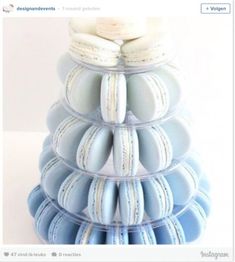 a stack of blue and white macaroons sitting on top of each other