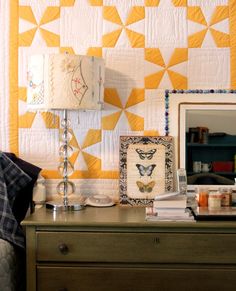 a bed room with a neatly made bed and a night stand