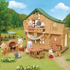 a toy house with many animals around it