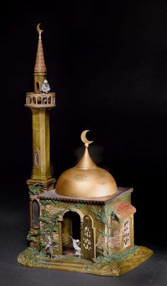 a small statue of a building with a gold dome