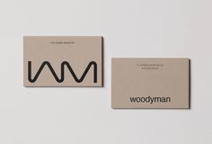 two business cards designed to look like the logo for woodyman, which has been printed on