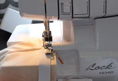 the sewing machine is being used to sew fabric on it's sides,