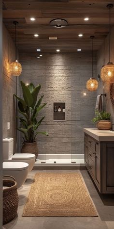 a bathroom with two sinks, a toilet and a bathtub next to a plant