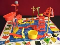 a game board with toys on it and some pieces of construction in the foreground