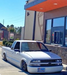 a white truck parked in front of a building