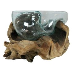 a glass bowl sitting on top of a piece of wood