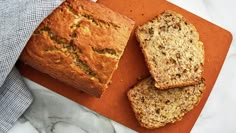 three slices of banana bread on an orange cutting board