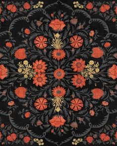 an intricately designed rug with red flowers and leaves on black ground, in the middle of