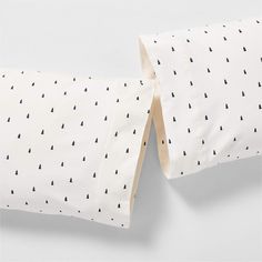 two pillow cases with trees printed on them