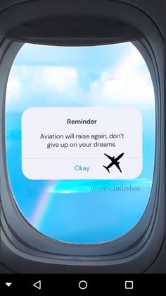 an airplane window with the words reminder written on it, and there is a rainbow in the sky