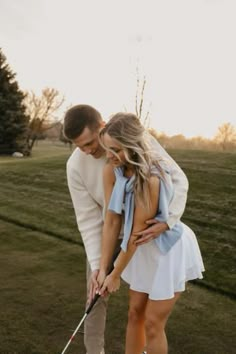 a man and woman are playing golf together