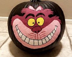 a painted pumpkin with an evil face on it