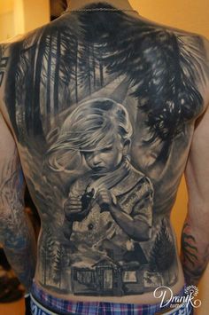 the back of a man's tattoo with a girl holding a bird and trees