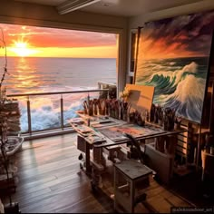 an artist's studio with the sun setting over the ocean