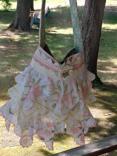 a dress hanging from a tree in the park