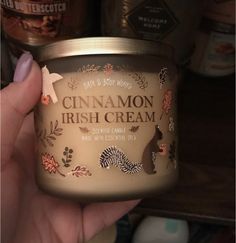 a hand holding a jar of cinnamon irish cream