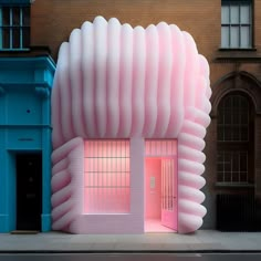 a large pink building sitting on the side of a road