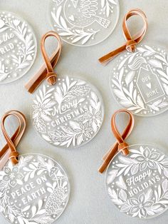 four christmas ornaments with ribbons on them