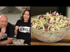 two people sitting in front of a bowl of salad