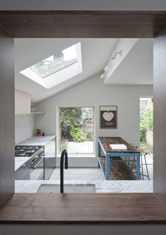 an open kitchen with skylights above it