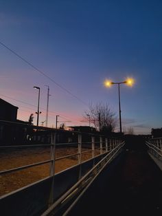 an empty road at night with street lights