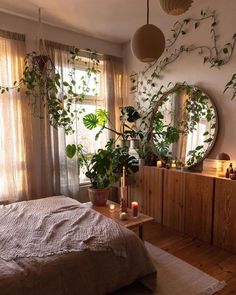 a bed room with a neatly made bed and lots of plants