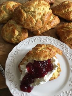 scones with jam and cream on a white plate