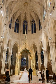 the bride and groom are getting married in front of the alter at st patrick's cathedral