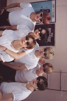 three women standing next to each other in white dresses and sunglasses with their arms around one another