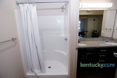 a bathroom with a sink, mirror and bathtub