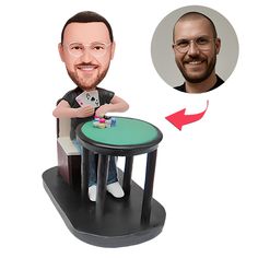 a bobble head sitting on top of a table next to a man with glasses