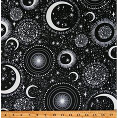 a black and white fabric with stars, moon and circles on it's surface