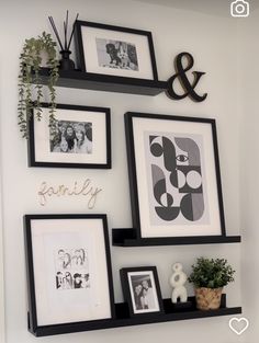 some black and white pictures are hanging on the wall next to other framed photos,